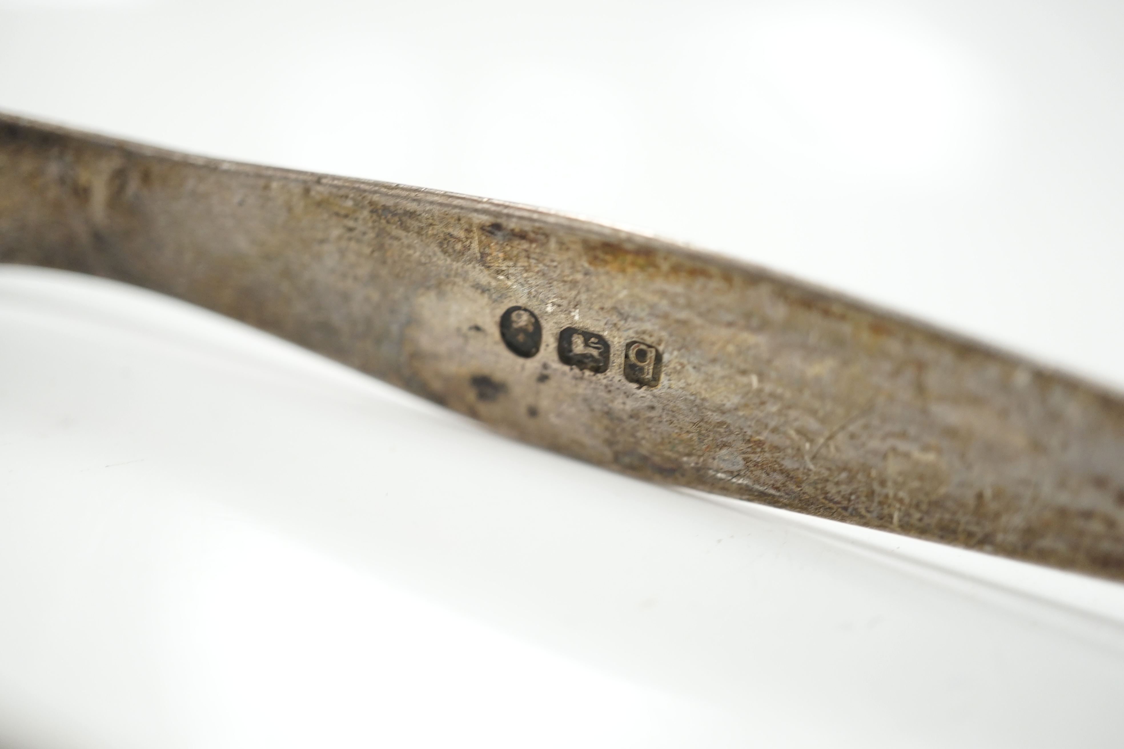 A pair of George V silver grape scissors, Sheffield, 1929, 18.6cm, together with a mother of pearl handled silver butter knife ad a pair of Georgian silver sugar tongs by Peter & Ann Bateman. Condition - poor to fair